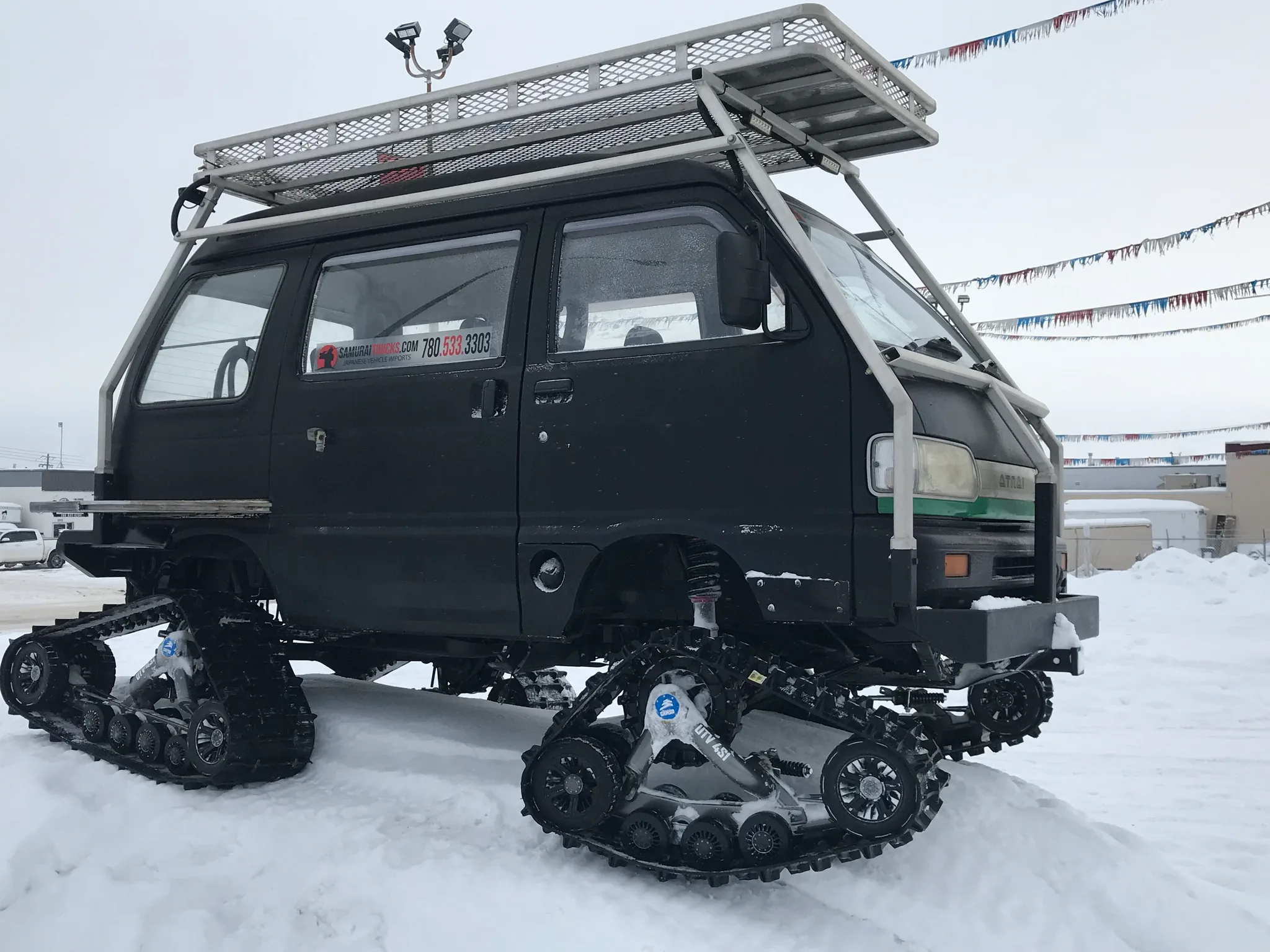 Camso track units on the 1991 Daihatsu Atrai, side view in snow